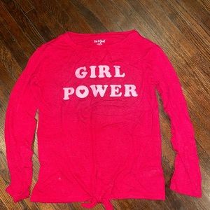 “Girl Power” long-sleeved shirt. Knot-tie in front.